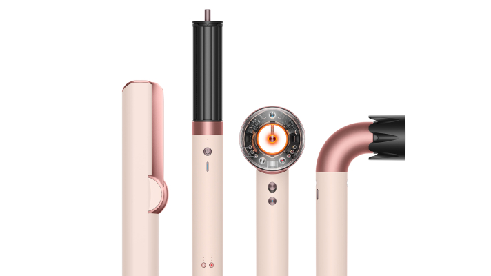 Woman vacuuming living room floor with Dyson vacuum