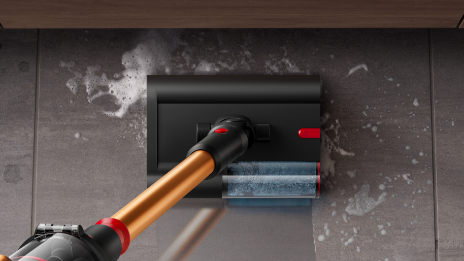 Dyson wet and dry vacuum cleaner is used to clean a pill on the tile floor.